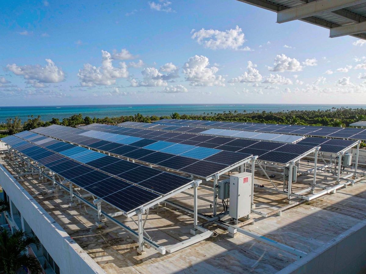 Commercial rooftop solar array on a Caribbean island building engineered for hurricane wind loads