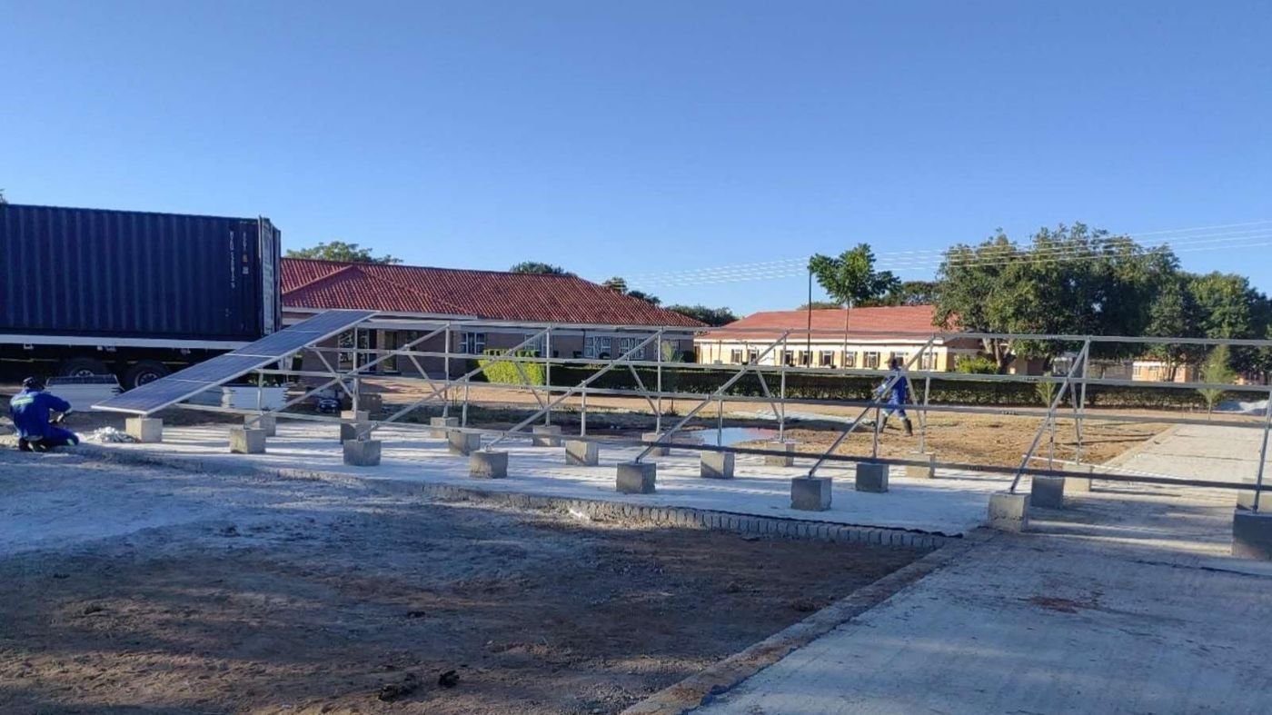 Engineers installing a 100kW commercial solar power system