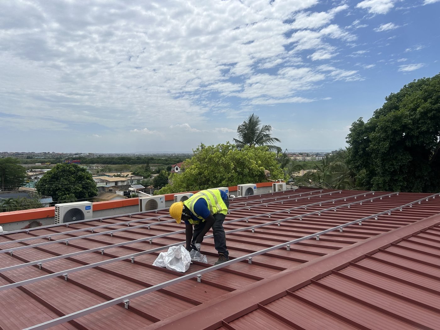Technicians installing the rooftop array of a 250kW hotel solar system in Ghana